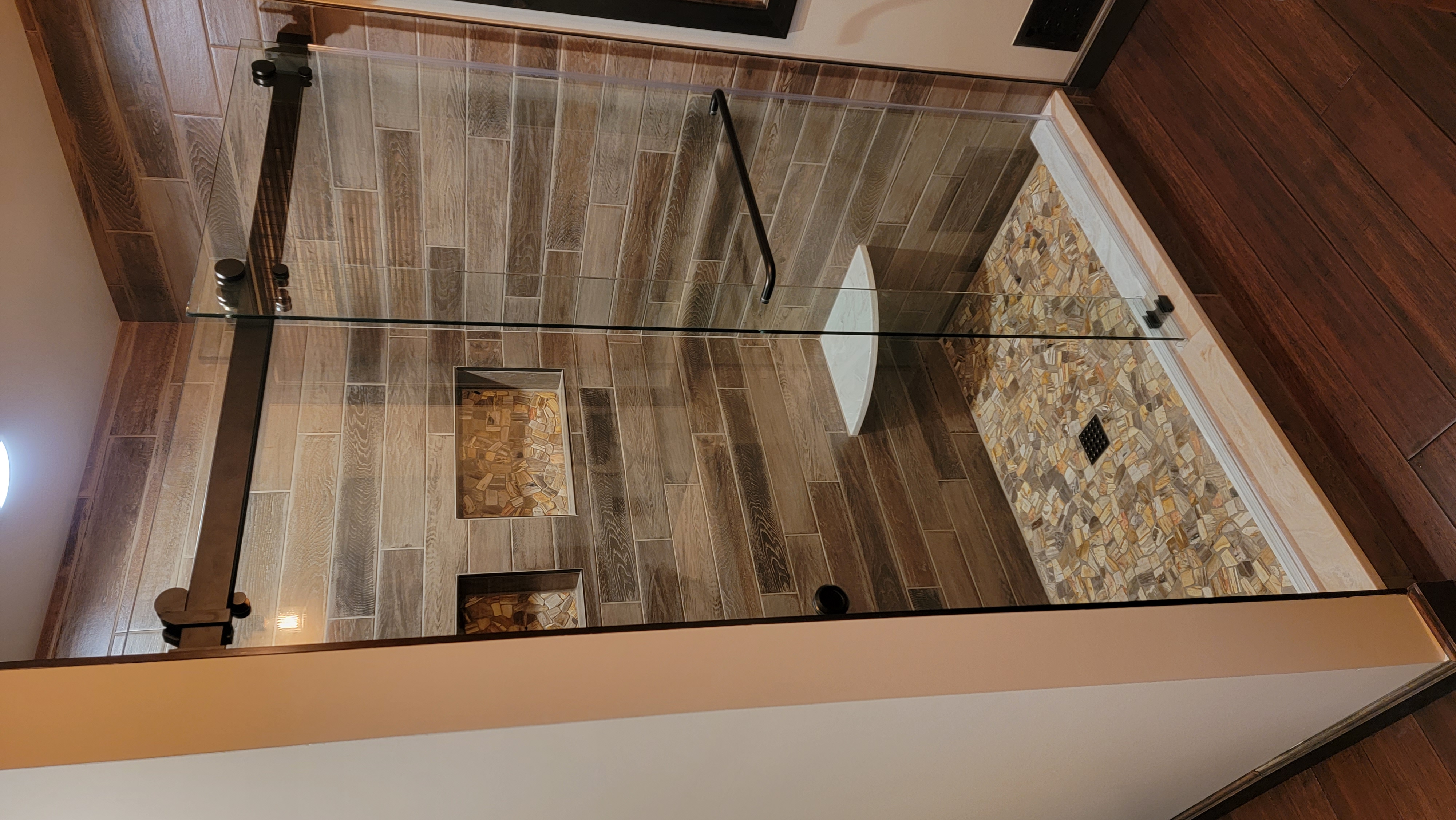 Master bath with petrified wood shower floor and porcelain plank walls in Cumberland, MD